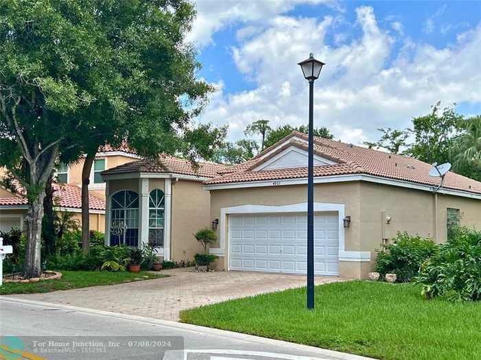 photo 1: 4803 NW 59th Ct, Coconut Creek FL 33073