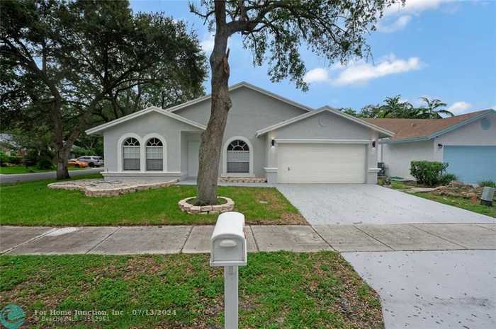 photo 1: 5850 NW 37th Ave, Coconut Creek FL 33073