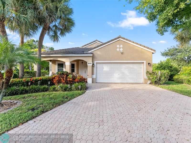 photo 1: 4845 NW 58th Pl, Coconut Creek FL 33073