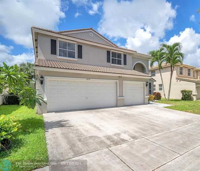 photo 1: 4839 NW 55th Dr, Coconut Creek FL 33073