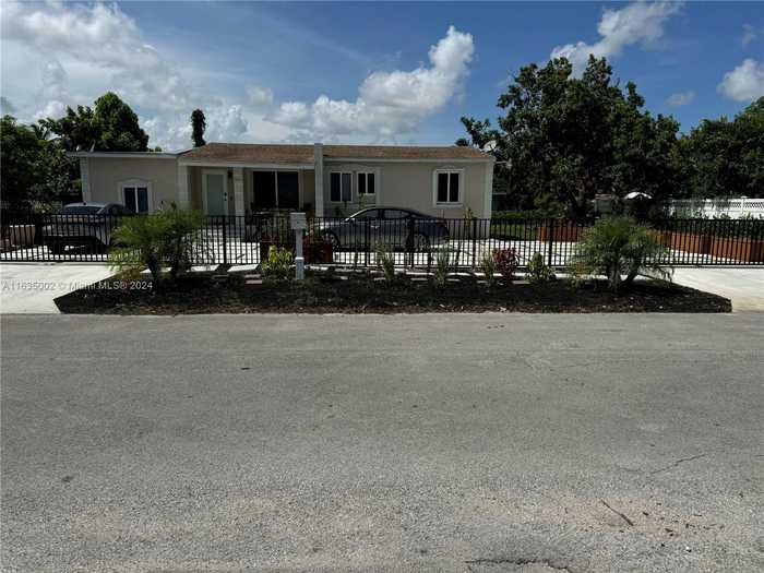 photo 1: 1001 NW 148th St, Miami FL 33168